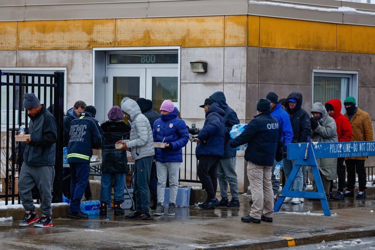 A group of illegal immigrants receives food in Chicago, Ill., on Jan. 12, 2024. (Kamil Krzaczynski/AFP via Getty Images)
