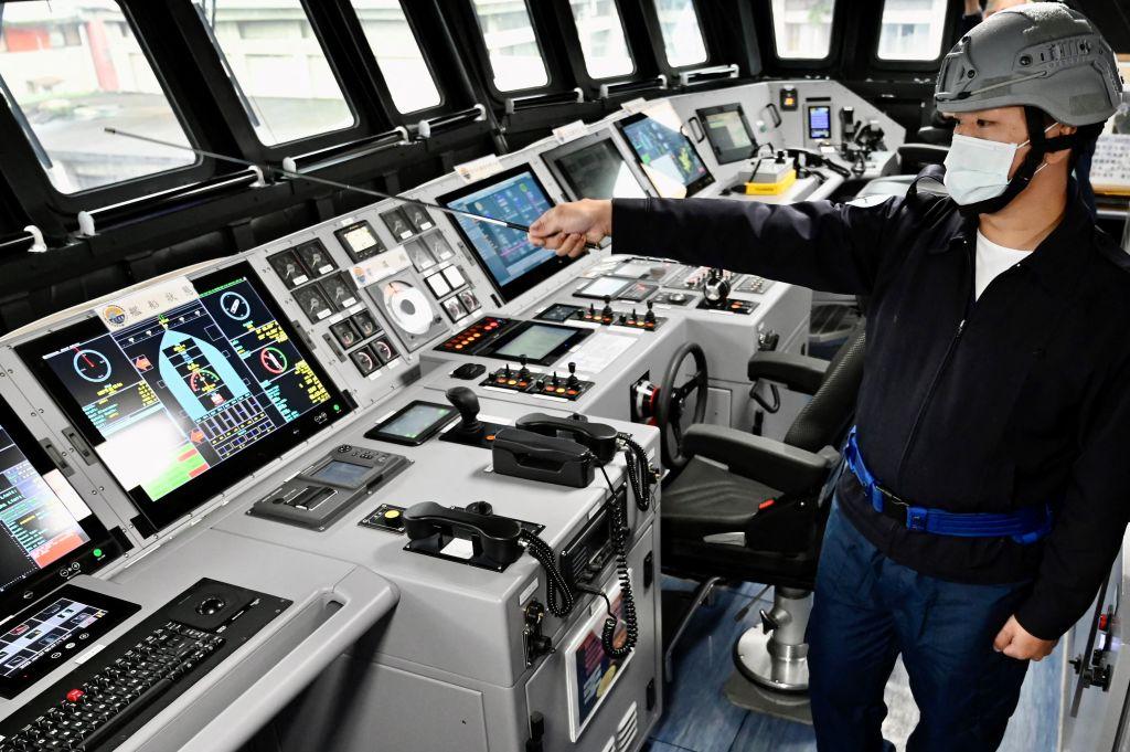 A Taiwan Navy instructor points at the control room during a media tour of the domestically produced corvette class vessel Tuo Chiang at the northern city of Keelung, Taiwan, on Jan. 7, 2022. (Sam Yeh/AFP via Getty Images)