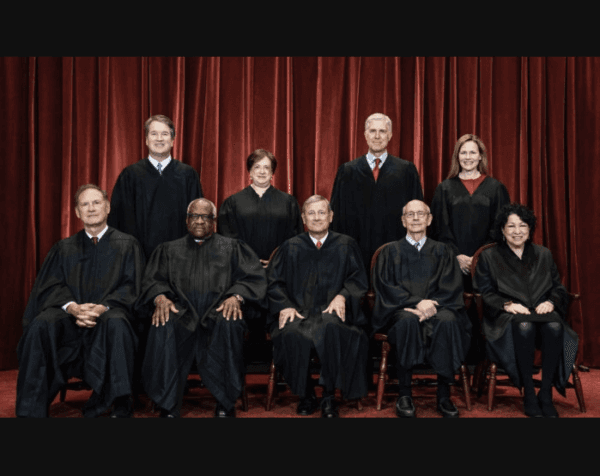 Members of the Supreme Court pose for a group photo at the Supreme Court in Washington on April 23, 2021. Standing from left: Justices Brett Kavanaugh, Elena Kagan, Neil Gorsuch, and Amy Coney Barrett. (Erin Schaff/Pool/Getty Images)