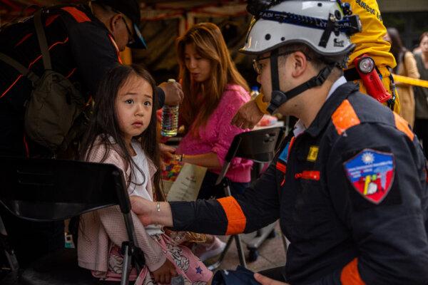 A child is given medical care at a temporary rescue command post in Hualien, Taiwan, on April 5, 2024. (Annabelle Chih/Getty Images)