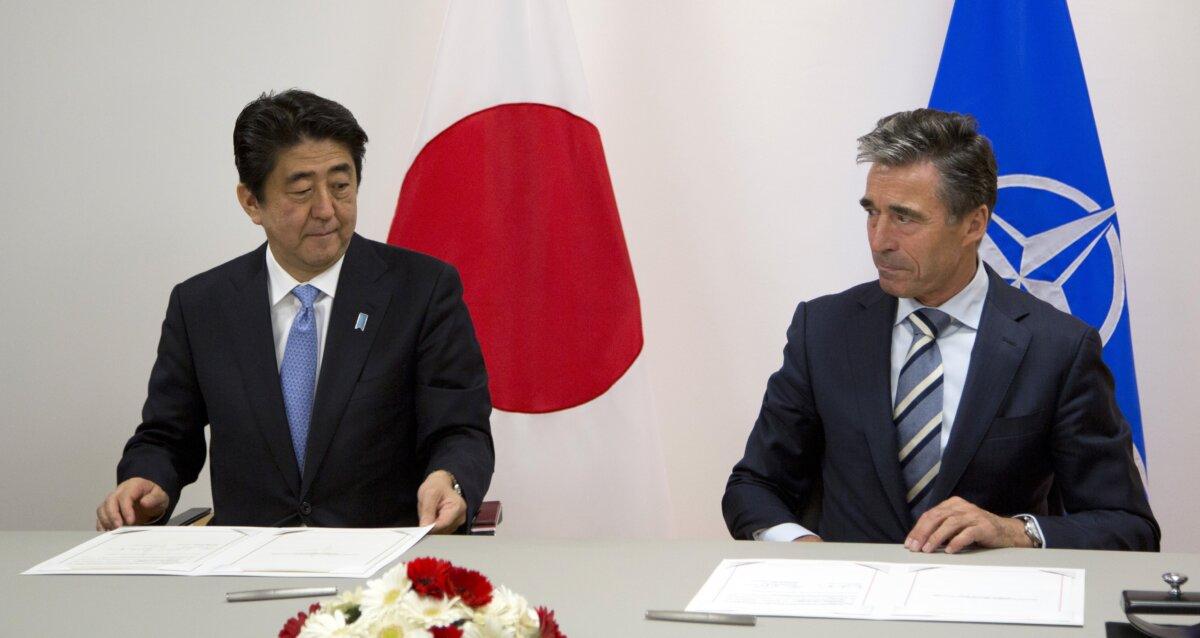 NATO Secretary General Anders Fogh Rasmussen (R) and Japanese Prime Minister Shinzo Abe (L) signed a corporation agreement at the NATO headquarters in Brussels on May 6, 2014. (Virginia Mayo/AFP via Getty Images)