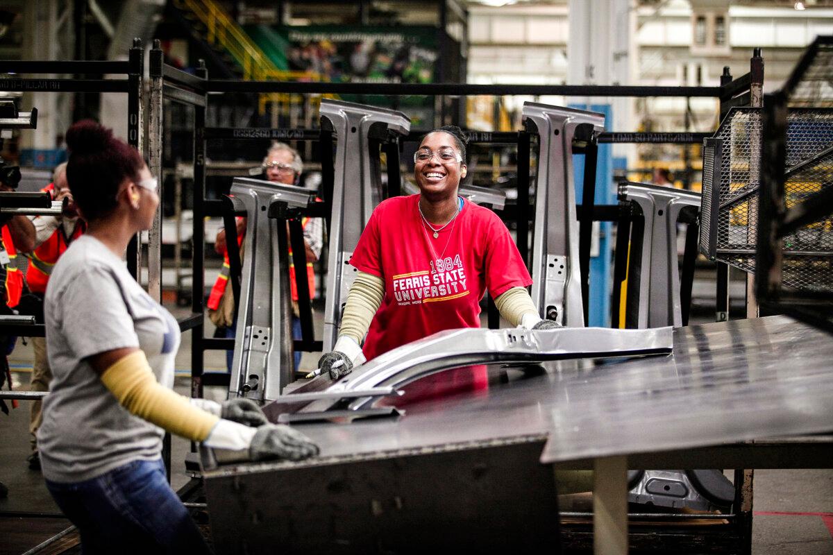 Workers handle parts for Fiat Chrysler Automobiles as they come off the press at the FCA Sterling Stamping Plant in Sterling Heights, Mich., on Aug. 26, 2016. (Bill Pugliano/Getty Images)