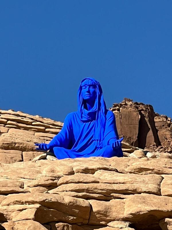 The Blue Lady in AlUla seated among the rocks in the lotus position. (Brenda O'Neale/TNS)