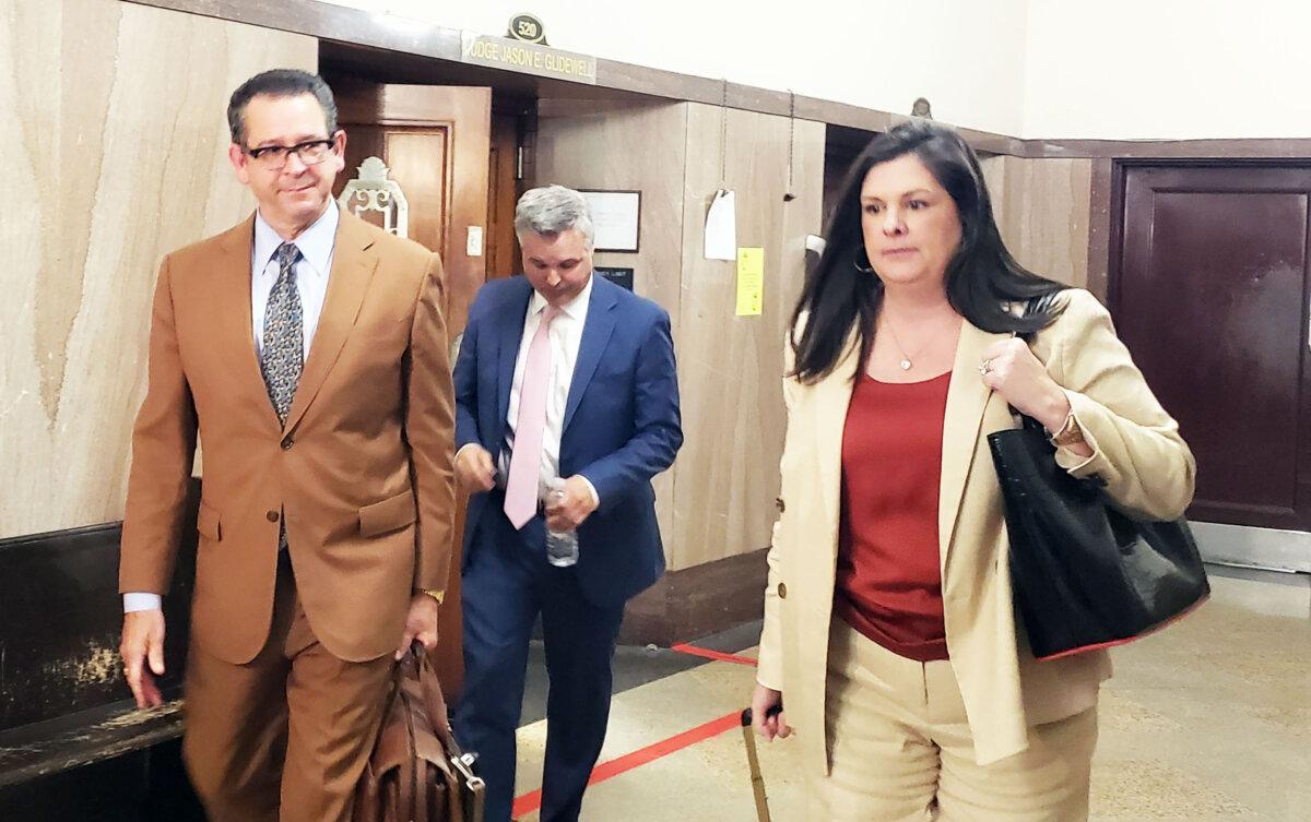 Oklahoma City lawyer Joe White (L) leaves a District Court of Oklahoma County courtroom with Ben Harris (C) and co-counsel Kate White (R) on March 25, 2024. (Michael Clements/The Epoch Times)