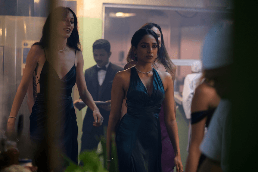 Sita (Sobhita Dhulipala, in green dress) a high-class prostitute and ally of Kid, in "Monkey Man." (Universal Pictures)