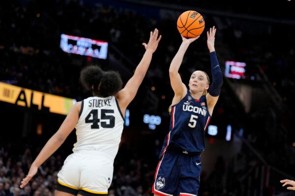 Paige Bueckers of UConn shoots over Iowa's Hannah Stuelke during an NCAA women's Final Four game in Cleveland on April 5, 2024. (Morry Gash/AP Photo)