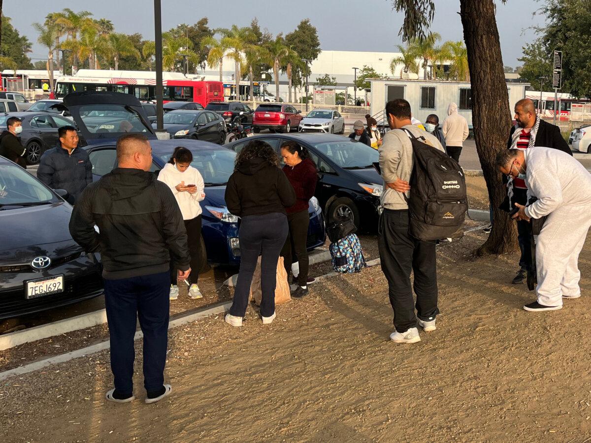 Illegal immigrants in San Diego who just got off unmarked buses chartered by U.S. Border Patrol are released at a bus and tram stop to move further into the United States after minimal screening. For Mandarin speakers, a row of Toyota Priuses with Chinese cabdrivers await. (Simon Hankinson/The Heritage Foundation)