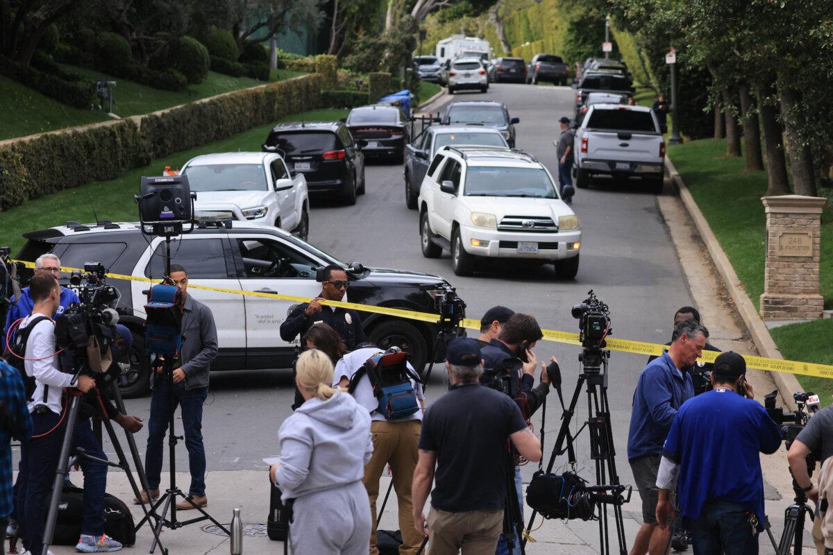 Police and media members gather outside the home of U.S. producer and musician Sean "Diddy" Combs in Los Angeles on March 25, 2024. Homes belonging to Sean "Diddy" Combs were being raided by federal agents, media reported on March 25, with the U.S. hip hop mogul at the center of sex trafficking and sex assault lawsuits. (David Swanson/AFP via Getty Images)