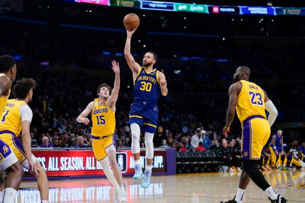 Warriors star Stephen Curry avoids the Lakers' defense in Los Angeles on April 9, 2024. (Ryan Sun/AP Photo)