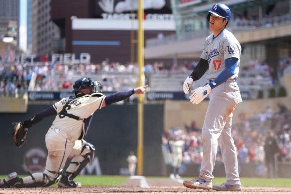 Dodgers designated hitter Shohei Ohtani reacts after being tagged out at the plate by Twins catcher Christian Vázquez in Minneapolis on April 10, 2024. (Abbie Parr/AP Photo)