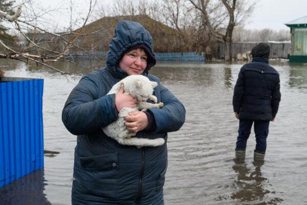 Residents in the flooded settlement of Pokrovka, in northern Kazakhstan close to the border with Russia, on April 9, 2024. Water levels in overflowing rivers were still rising on April 9 in swaths of Russia and Kazakhstan that have been hit by massive floods. (Evgeniy Lukyanov/AFP via Getty Images)