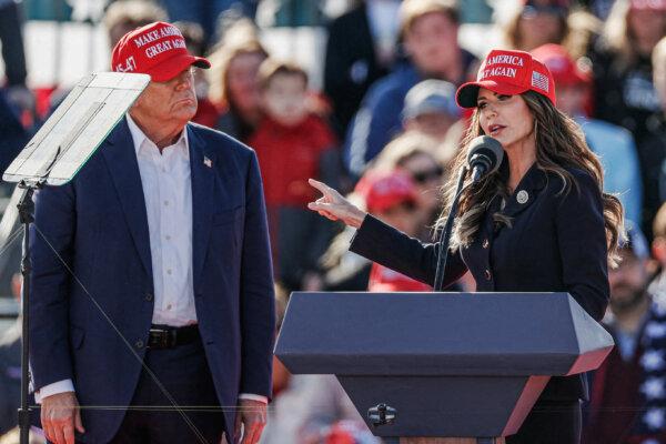 Former President Donald Trump listens as North Dakota Gov. Kristi Noem speaks during a rally in Vandalia, Ohio, on March 16, 2024. (Kamil Krzacynski/AFP via Getty Images)