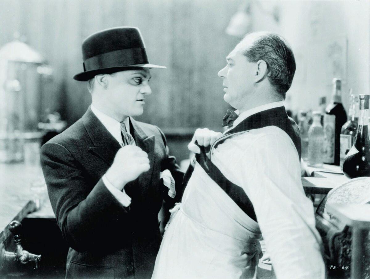 Tom Powers (James Cagney, L) bullies Steve the bartender (Lee Phelps), in "The Public Enemy." (Warner Bros.)