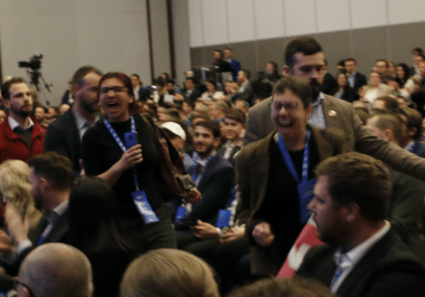 Protesters from the environmental activist group Last Generation Canada disrupt Conservative Leader Pierre Poilievre's speech at the Canada Strong and Free Network conference in Ottawa on April 11, 2024. (Noé Chartier/The Epoch Times)
