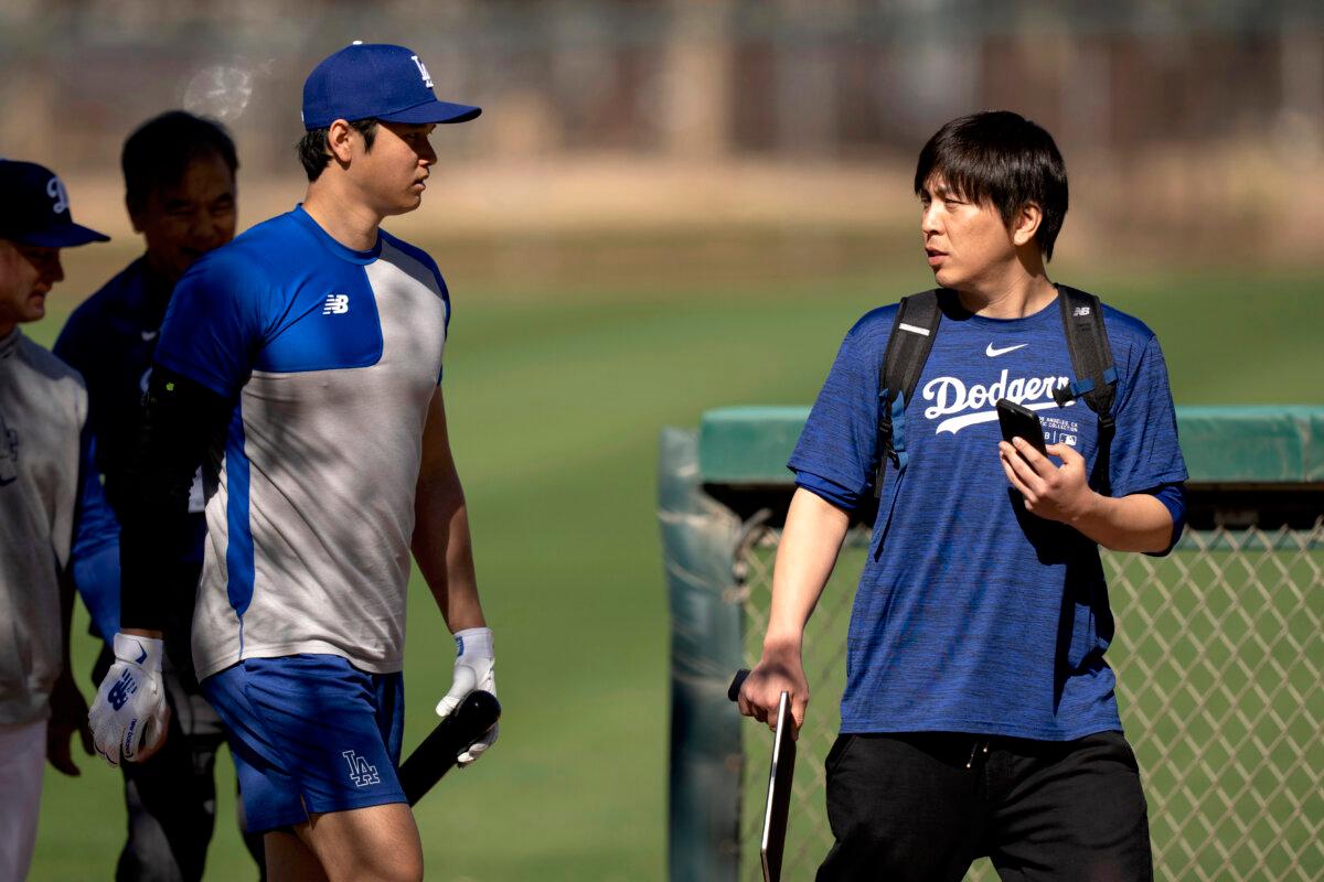 Los Angeles Dodgers' Shohei Ohtani (L) walks with interpreter Ippei Mizuhara at batting practice during spring training baseball workouts in Phoenix on Feb. 12, 2024. (Carolyn Kaster/AP Photo)