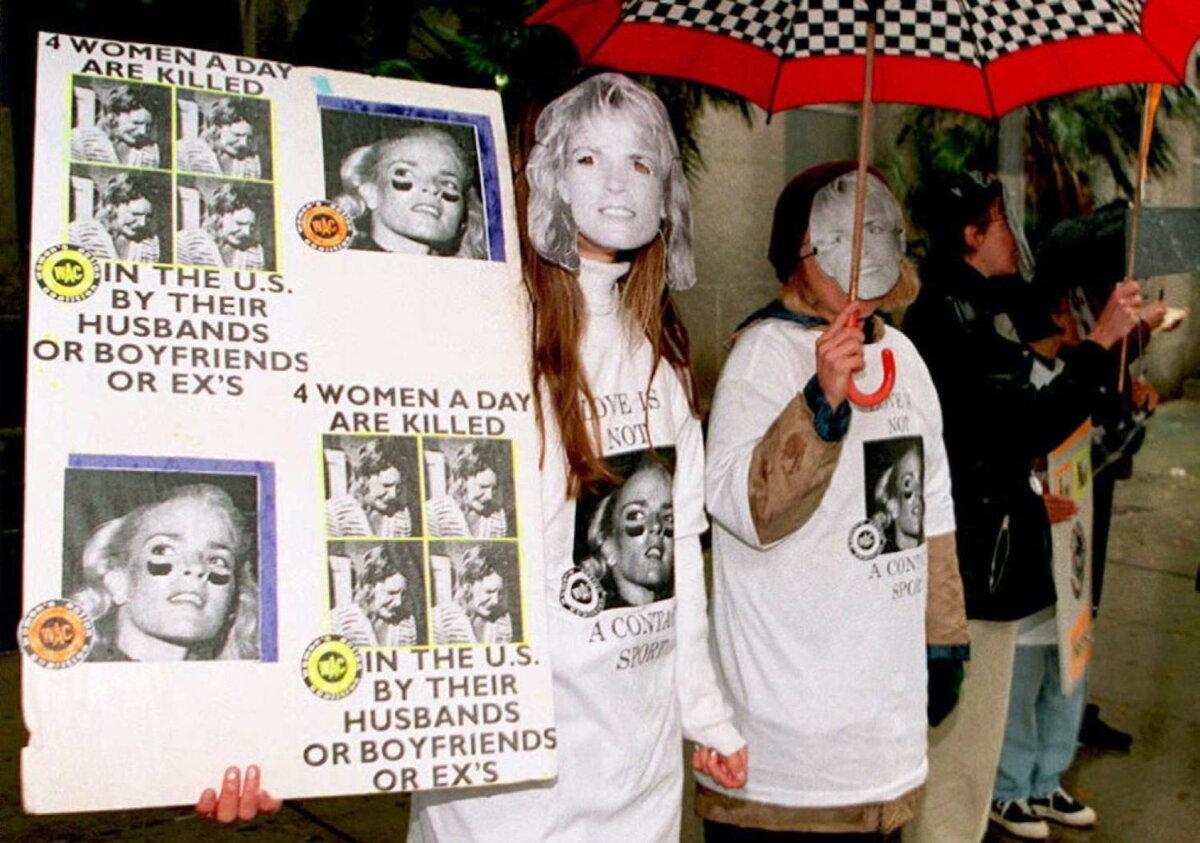 Members of the Women's Action Coalition wearing Nicole Brown Simpson masks protest against spousal abuse outside the Criminal Courts Building where opening statements in the O.J. Simpson murder trial were expected on Jan. 23, 1995, in Los Angeles. (Vince Bucci/AFP via Getty Images)