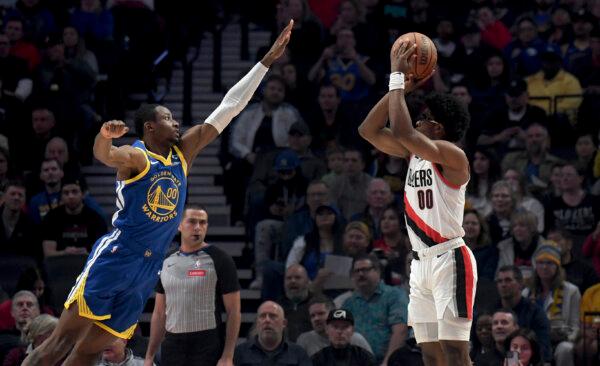 Jonathan Kuminga of the Warriors defends a shot by Trail Blazers guard Scoot Henderson during an NBA game in Portland, Ore., on April 11, 2024. (Steve Dykes/AP Photo)
