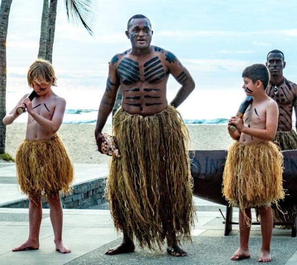 Daring travelers join a Fijian warrior at the Intercontinental Fiji Golf Resort & Spa evening Torch Lighting Ceremony, Fiji Islands. (Steve Haggerty/TNS)