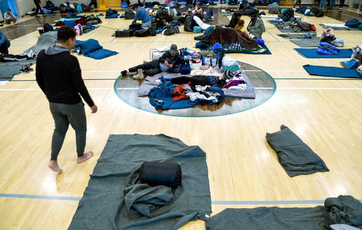 Illegal immigrants rest at a makeshift shelter in Denver, Colo., on Jan. 6, 2023. (Thomas Peipert/AP Photo)