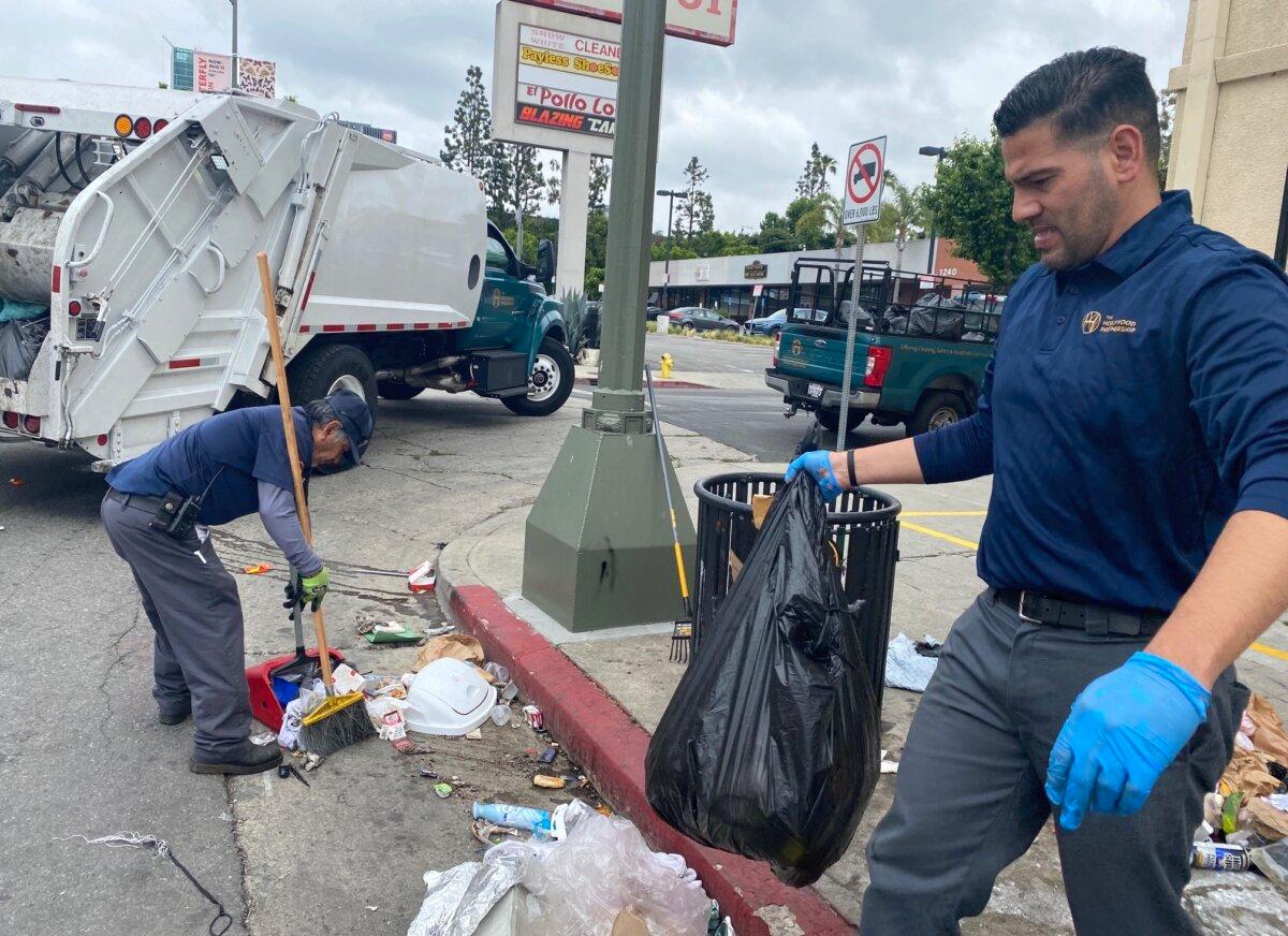 The Hollywood Partnership, a business improvement district team funded by local businesses, cleans up trash on Vine Ave in Los Angeles. (Courtesy of Keith Johnson)