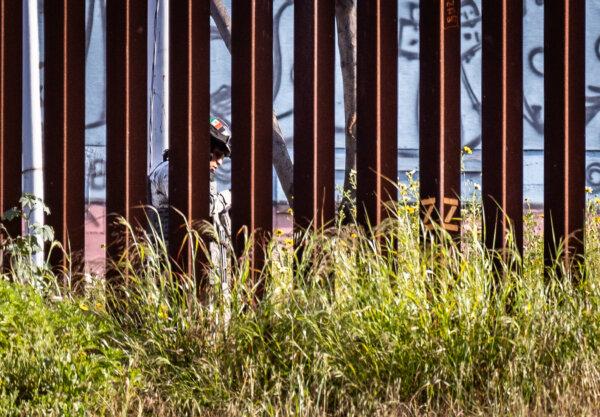 The Mexican military guards a gap in the U.S.–Mexico border wall as seen from San Ysidro, Calif., on April 12, 2024. (John Fredricks/The Epoch Times)