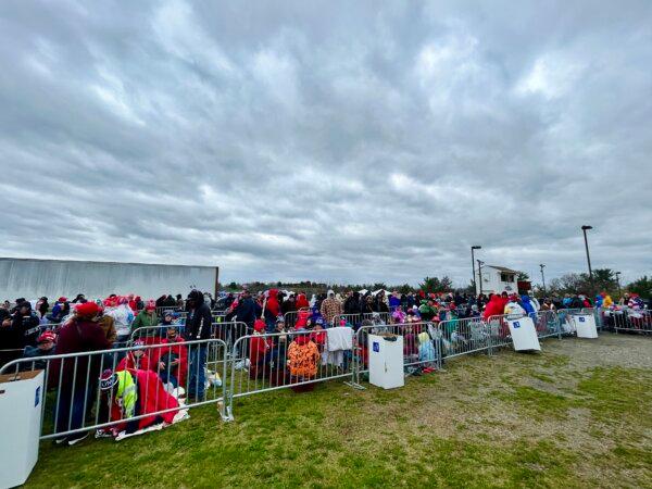 Hundreds of people wait under rainy, cloudy skies eight hours in advance of former President Donald Trump's campaign speech in Schnecksville, Pa., on April 13, 2024. (Iris Tao/The Epoch Times)
