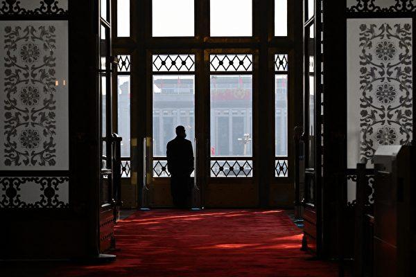 A member of security stands guard at an entrance during the closing ceremony of the Chinese People's Political Consultative Conference (CPPCC) at the Great Hall of the People in Beijing on March 10, 2024. (Photo by Jade Gao / AFP)