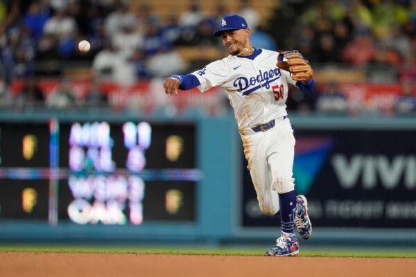 Los Angeles Dodgers shortstop Mookie Betts throws out San Diego Padres' Jackson Merrill at first base on a ground ball during the fourth inning of a baseball game in Los Angeles on April 13, 2024. (Marcio Jose Sanchez/AP Photo)