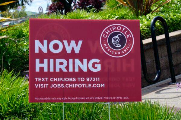 A hiring sign in front of a Chipotle restaurant in Pittsburg, Calif., on April 6, 2024. (Travis Gillmore/The Epoch Times)