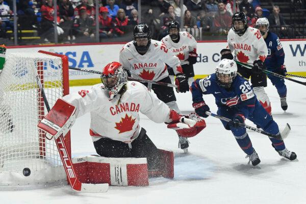 Canadian goaltender Ann-Renee Desbiens pushes the puck wide as Kendall Coyne Schofield of the United States pursues during the IIHF Women's World Hockey Championships in Utica, N.Y., on April 14, 2024. (Adrian Kraus/AP Photo)