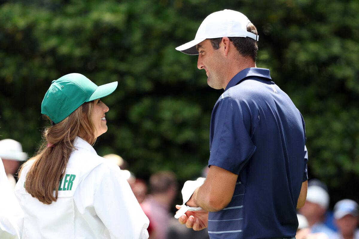 Scottie Scheffler of the United States talks with his wife, Meredith Scheffler, during the Par 3 contest prior to the 2023 Masters Tournament at Augusta National Golf Club in Augusta, Ga. on April 5, 2023. (Patrick Smith/Getty Images)