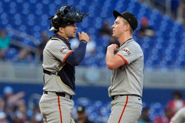 Giants catcher Patrick Bailey and rookie left-hander Kyle Harrison talk strategy during a game against the Marlins in Miami on April 15, 2024. (Marta Lavandier/AP Photo)
