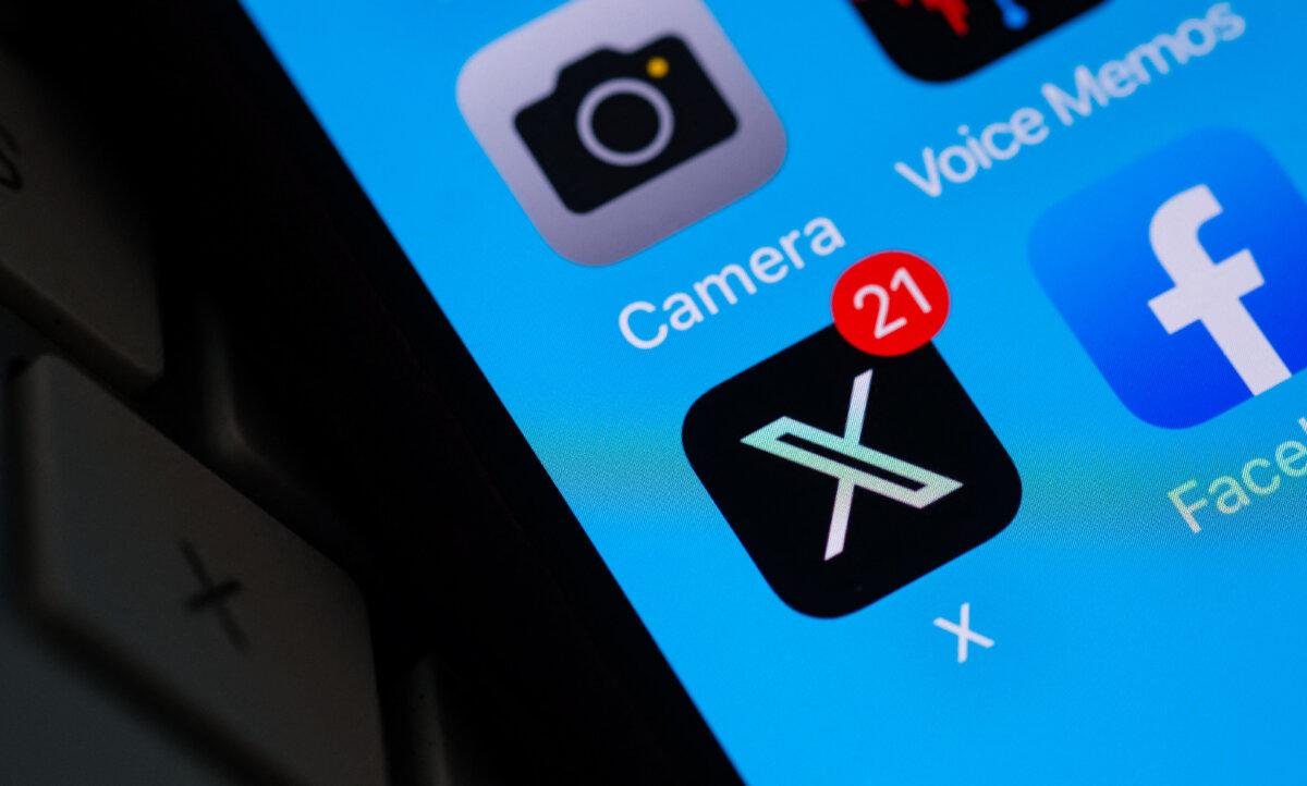 The X logo on a smartphone screen in Los Angeles on July 31, 2023. (Chris Delmas/AFP via Getty Images)