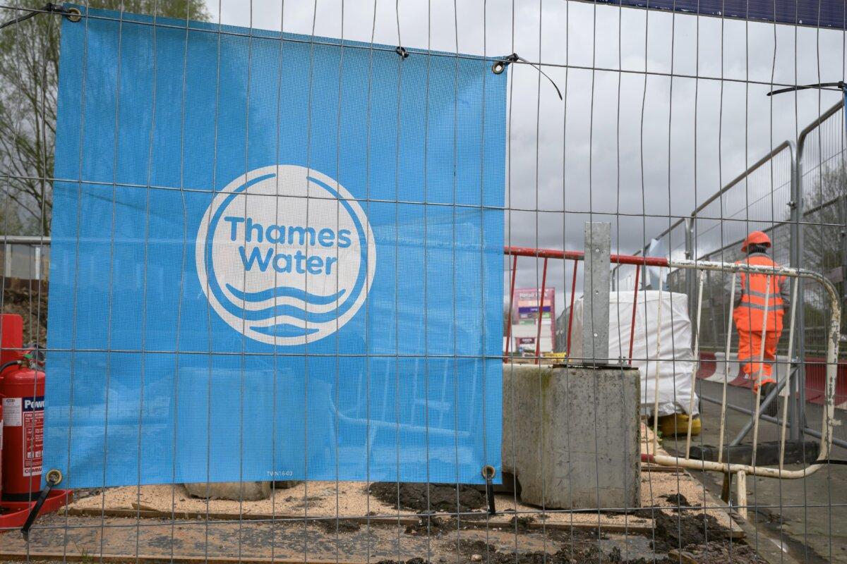 The Thames Water logo is seen on protective fencing around a pipework replacement site in London on April 4, 2024. (Leon Neal/Getty Images)