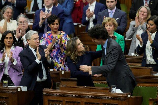 Finance Minister Chrystia Freeland receives applause as she shakes hands with Prime Minister Justin Trudeau after presenting the federal budget in the House of Commons on April 16, 2024. (The Canadian Press/Adrian Wyld)