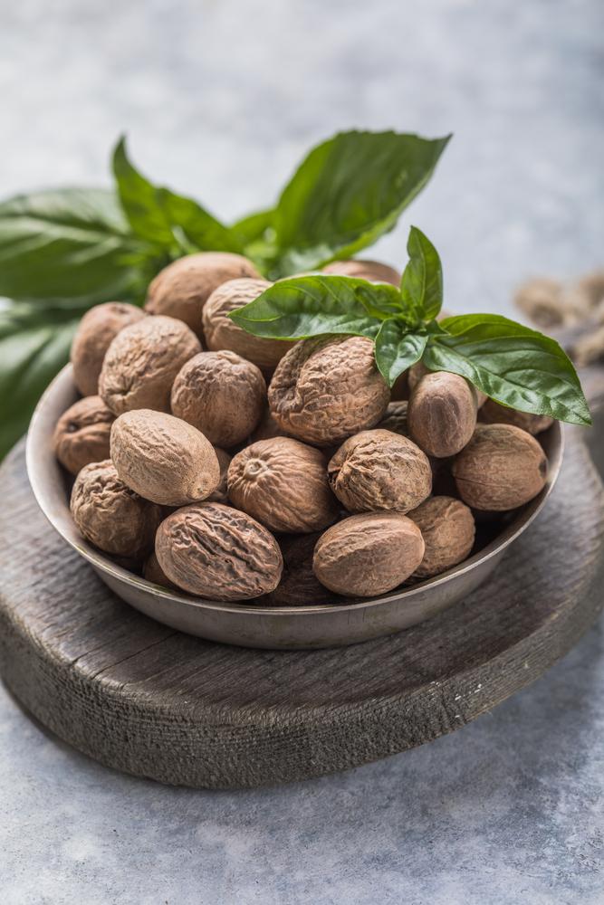 Whole nutmeg has a distinctively warm, sweet, and aromatic flavor, often described as slightly nutty and peppery.(Sokor Space/Shutterstock)