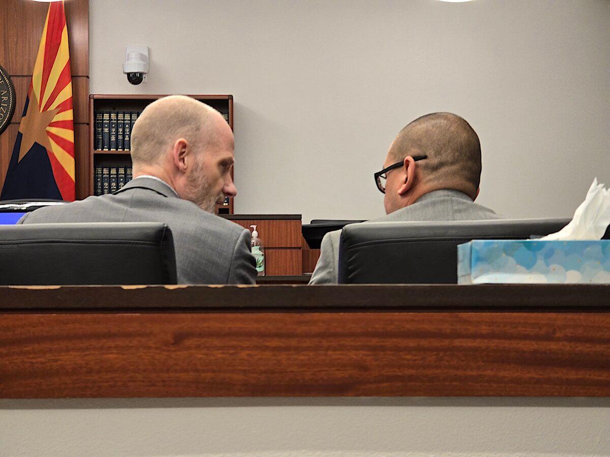 Pima County Attorney Michael Jetty (L), a prosecutor in the George Alan Kelly murder trial, confers with Sheriff's Office Detective Jorge Ainza on April 16, 2024. (Allan Stein/The Epoch Times)