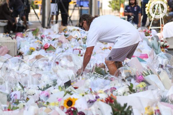 People lay flowers outside Westfield Shopping mall in honour of the victims on April 16, 2024 in Bondi Junction, Australia. (Photo by Brendon Thorne/Getty Images)