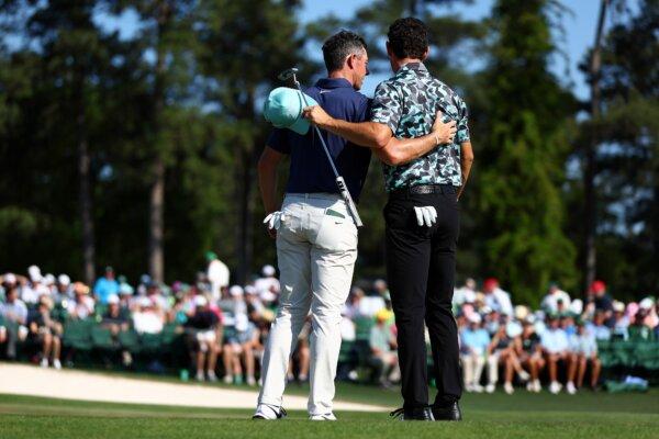 Rory McIlroy of Northern Ireland (L) and Joaquin Niemann of Chile meet on the 18th green after finishing their round during the final round of the 2024 Masters Tournament at Augusta National Golf Club in Augusta, Georgia, on April 14, 2024. (Maddie Meyer/Getty Images)