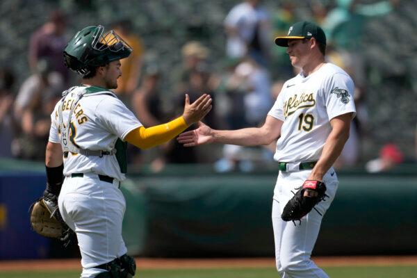A's catcher Shea Langeliers (L) and closer Mason Miller exchange a greeting after a 6–3 win over the Cardinals in Oakland, Calif., on April 17, 2024. (Jeff Chiu/AP Photo)