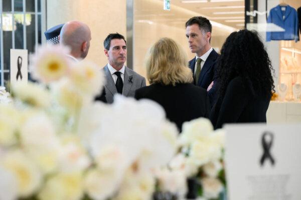 Scentre Group Chief Executive Elliott Rusanow (L), and NSW Premier Chris Minns (R) visit the memorial to the victims who lost their lives in Saturday's knife attack on April 18, 2024 in Sydney, Australia. (Photo by Bianca di Marchi - Pool/Getty Images)