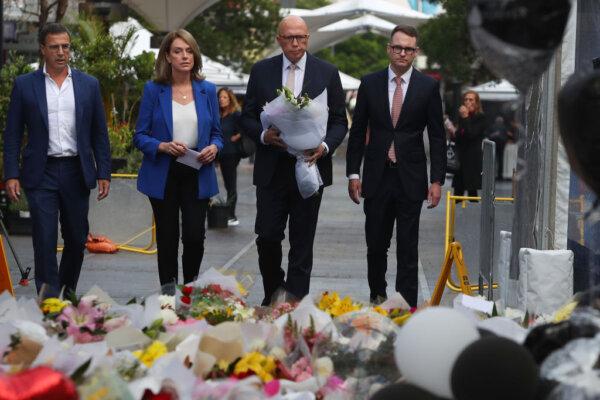 Richard Shields, Kellie Sloan, Australian Opposition Leader Peter Dutton and Senator Andrew Bragg lay flower tributes at the edge of Westfield Bondi Junction during a day of reflection on April 18, 2024 in Sydney, Australia. (Photo by Lisa Maree Williams/Getty Images)