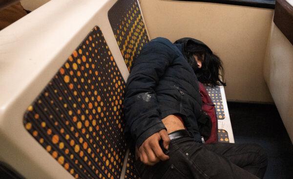 A man works off a drug high on the Los Angeles Metro Line transit system in Los Angeles on April 19, 2023. (John Fredricks/The Epoch Times)