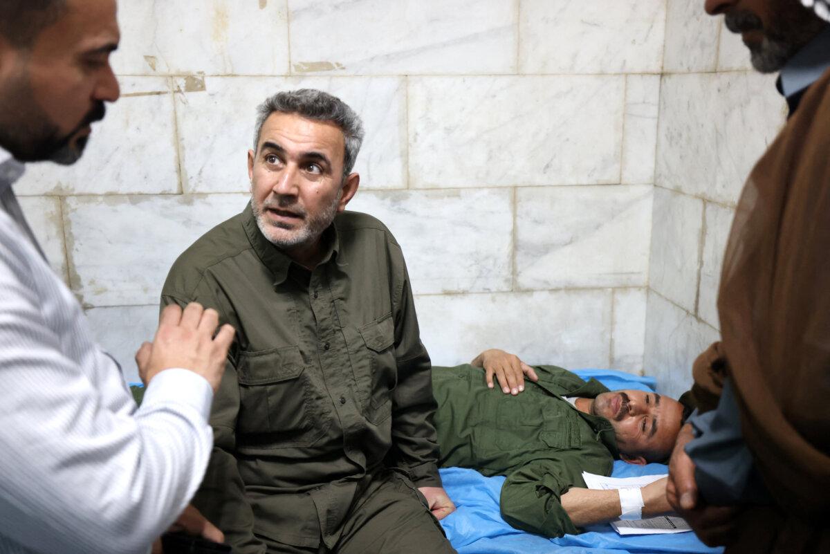 Abu Fadak Al-Mohammedawi, chief of staff of Iraq’s Popular Mobilization Forces, visits personnel at a hospital in the central province of Babylon, Iraq, on April 20, 2024. (Karar Jabbar/AFP via Getty Images)
