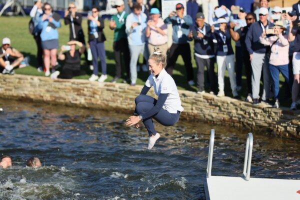 Nelly Korda of the United States jumps into the water after winning The Chevron Championship in The Woodlands, Texas, on April 21, 2024. (Andy Lyons/Getty Images)