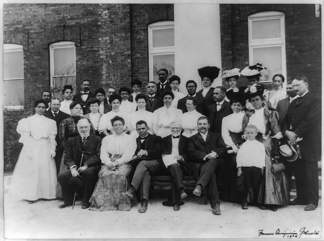 Booker T. Washington, the principal of Tuskegee Institute, poses outside what is presumably the university with other teachers and staff. (Public Domain)