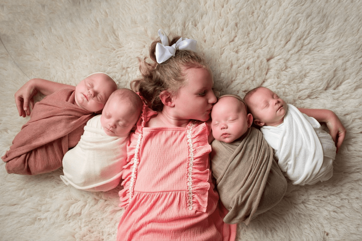 The couple's first daughter, Emily, with her quadruplet siblings. (SWNS)