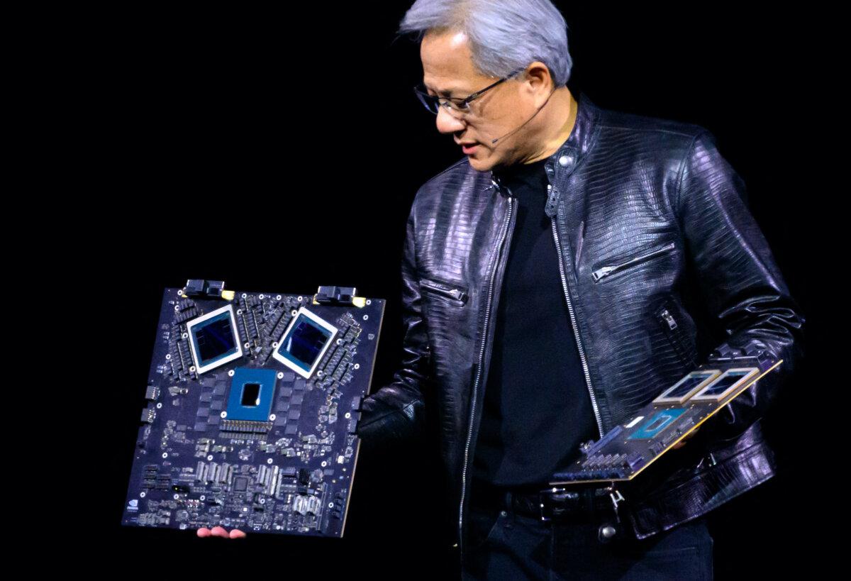 Nvidia's CEO Jensen Huang displays products on-stage during the annual Nvidia GTC Artificial Intelligence Conference at SAP Center in San Jose, Calif., on March 18, 2024. (Josh Edelson/AFP via Getty Images)