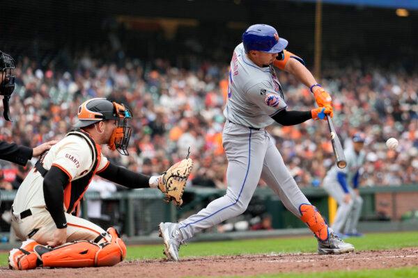 Giants catcher Patrick Bailey can only watch as Tyrone Taylor of the Mets slugs a two-run double in San Francisco on April 24, 2024. (Jeff Chiu/AP Photo)