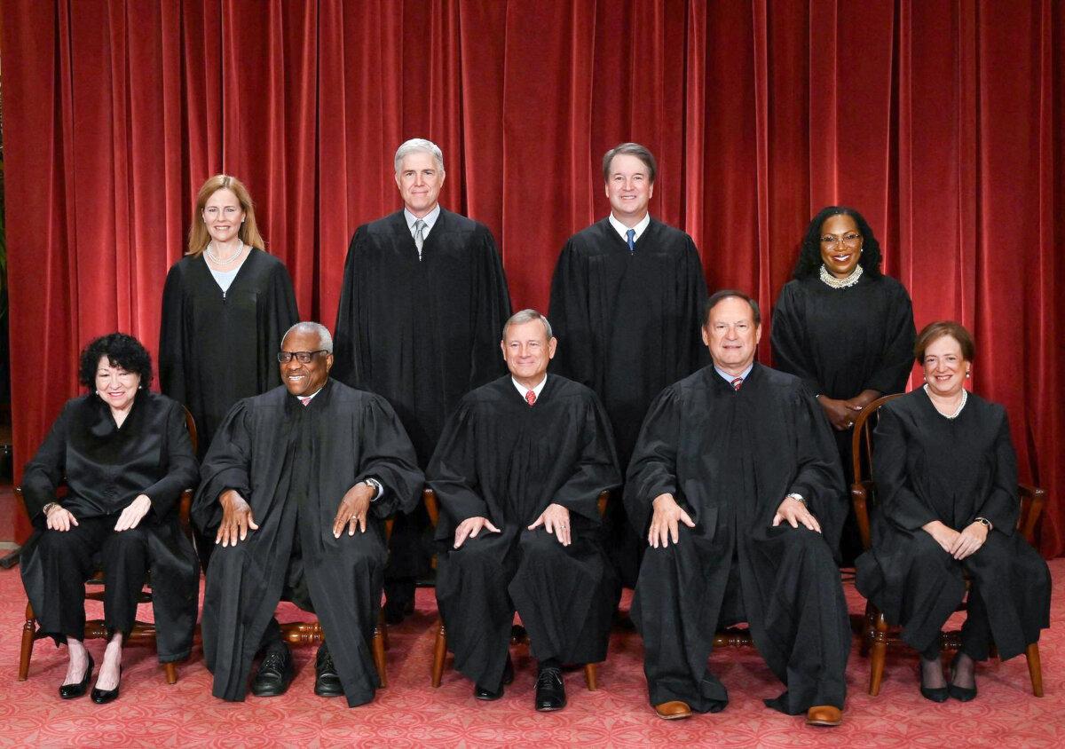 Justices of the U.S. Supreme Court pose for their official photo at the Supreme Court in Washington on Oct. 7, 2022. (Front L–R) Justices Sonia Sotomayor and Clarence Thomas, Chief Justice John Roberts, Justices Samuel Alito and Justice Elena Kagan. (Back L–R) Justices Amy Coney Barrett, Neil Gorsuch, Brett Kavanaugh, and Ketanji Brown Jackson. (Olivier Douliery/AFP via Getty Images)